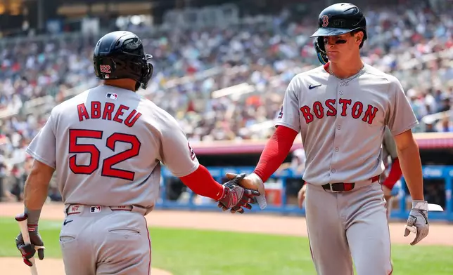 Boston Red Sox's Roman Anthony, right, celebrates with Wilyer Abreu after scoring on a single hit by Jarren Duran during the fifth inning of baseball game against the Minnesota Twins, Wednesday, July 30, 2025, in Minneapolis. (AP Photo/Matt Krohn)