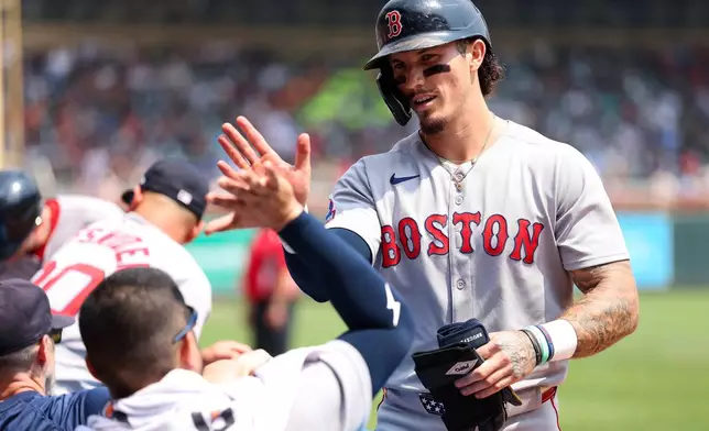 Boston Red Sox's Jarren Duran celebrates his two-run single against the Minnesota Twins during the fifth inning of baseball game, Wednesday, July 30, 2025, in Minneapolis. (AP Photo/Matt Krohn)