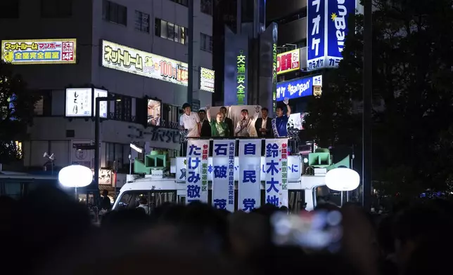 Japan's Prime Minister and Liberal Democratic Party President Shigeru Ishiba, center right, attends an election campaign event in support of his party's candidates on the eve of the July 20 Upper House election, in Tokyo, Saturday, July 19, 2025. (AP Photo/Louise Delmotte)