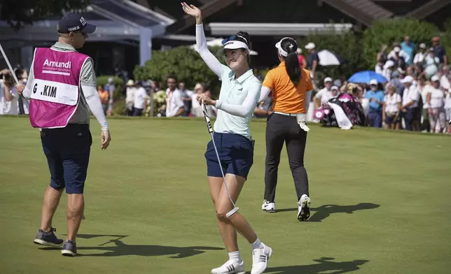 Grace Kim, of Australia, celebrates after winning the Evian Championship women's golf tournament, in Evian, eastern France, Sunday, July 13, 2025. (AP Photo/Laurent Cipriani)