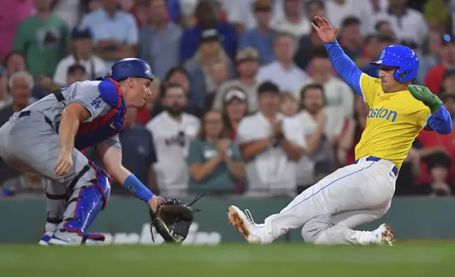 Boston Red Sox's Alex Bregman, right, scores in front of Los Angeles Dodgers catcher Will Smith, left, a double hit by Roman Anthony in the fifth inning of a baseball game, Saturday, July 26, 2025, in Boston. (AP Photo/Steven Senne)