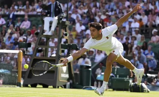 Carlos Alcaraz of Spain returns the ball to Oliver Tarvet of Britain in his second round men's singles match at the Wimbledon Tennis Championships in London, Wednesday, July 2, 2025.(AP Photo/Kirsty Wigglesworth)
