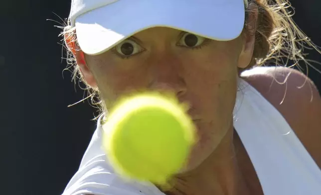 Argentina's Solana Sierra returns to Katie Boulter of Britain during their second round women's singles match at the Wimbledon Tennis Championships in London, Wednesday, July 2, 2025. (AP Photo/Alastair Grant)