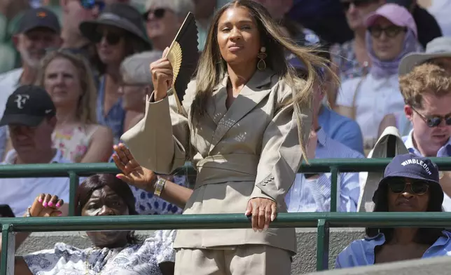 Ayan Broomfield the girlfriend of Frances Tiafoe of the U.S. watches as he plays Cameron Norrie of Britain during their second round men's singles match at the Wimbledon Tennis Championships in London, Wednesday, July 2, 2025. (AP Photo/Alastair Grant)