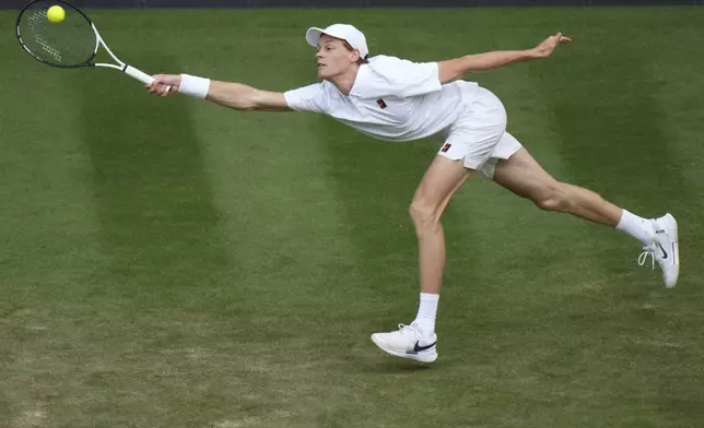 Jannik Sinner of Italy returns to Aleksandar Vukic of Australia during their second round men's singles match at the Wimbledon Tennis Championships in London, Thursday, July 3, 2025. (AP Photo/Alastair Grant)
