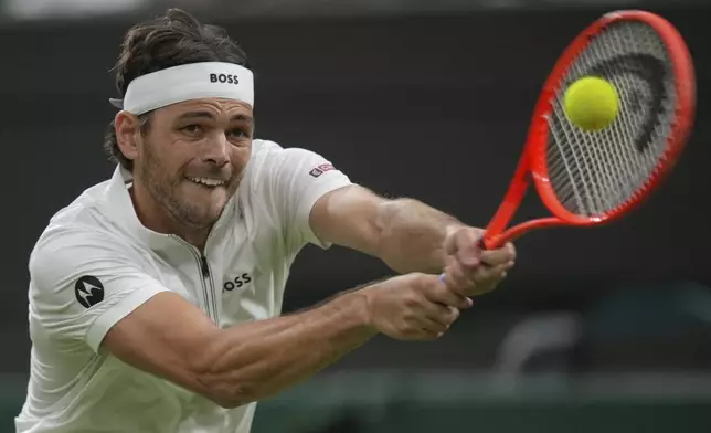 Taylor Fritz of the U.S. returns to Gabriel Diallo of Canada during their second round men's singles match at the Wimbledon Tennis Championships in London, Wednesday, July 2, 2025. (AP Photo/Alastair Grant)