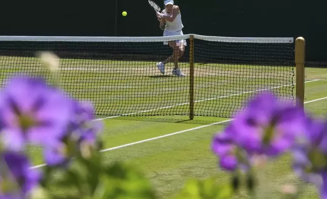 Xinyu Wang of China plays a return to Zeynep Sonmez of Turkey during their second round women's singles match at the Wimbledon Tennis Championships in London, Thursday, July 3, 2025.(AP Photo/Kirsty Wigglesworth)
