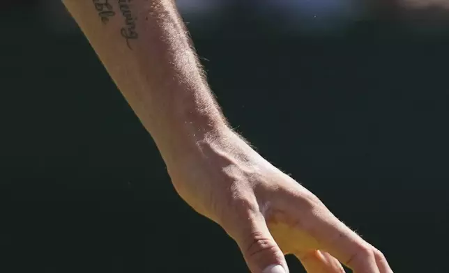 Lloyd Harris of South Africa prepares to serve to Andrey Rublev of Russia during their second round men's singles match at the Wimbledon Tennis Championships in London, Wednesday, July 2, 2025. (AP Photo/Joanna Chan)