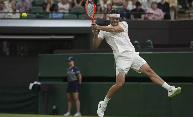 Taylor Fritz of the U.S. returns to Gabriel Diallo of Canada during their second round men's singles match at the Wimbledon Tennis Championships in London, Wednesday, July 2, 2025. (AP Photo/Alastair Grant)