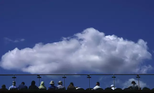 Spectators watch tennis on court three during the Wimbledon Tennis Championships in London, Thursday, July 3, 2025.(AP Photo/Kirsty Wigglesworth)
