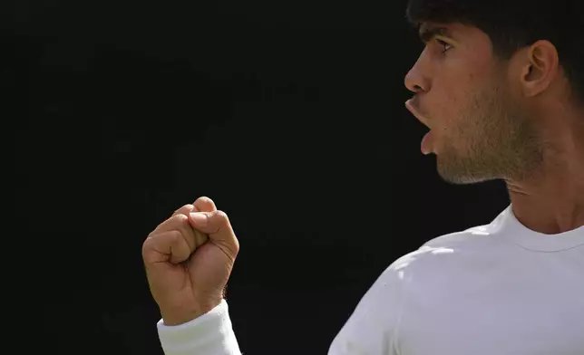 Carlos Alcaraz of Spain reacts in his second round men's singles match against Oliver Tarvet of Britain at the Wimbledon Tennis Championships in London, Wednesday, July 2, 2025.(AP Photo/Kirsty Wigglesworth)