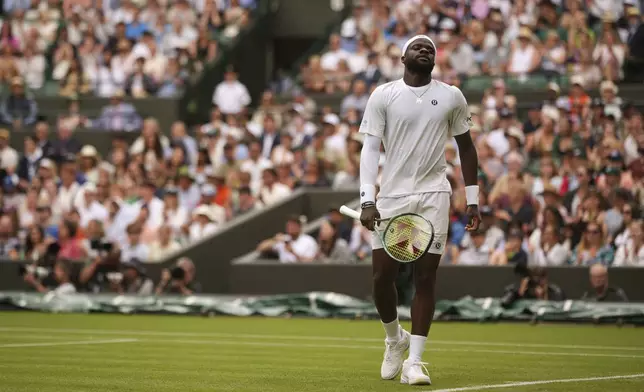 Frances Tiafoe of the U.S. reacts after missing a point as he plays Cameron Norrie of Britain during their second round men's singles match at the Wimbledon Tennis Championships in London, Wednesday, July 2, 2025. (AP Photo/Alastair Grant)