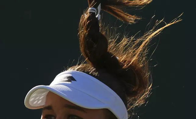 Russia's Kamilla Rakhimova serves to Jasmine Paolini of Italy during their second round women's singles match at the Wimbledon Tennis Championships in London, Wednesday, July 2, 2025. (AP Photo/Joanna Chan)