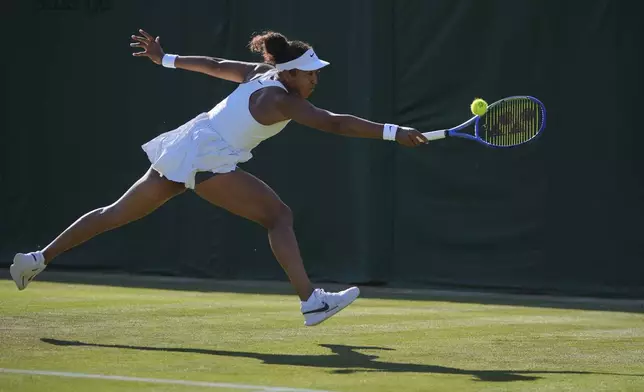 Naomi Osaka of Japan plays a return to Katerina Siniakova of Czech Republic during their second round women's single match at the Wimbledon Tennis Championships in London, Wednesday, July 2, 2025.(AP Photo/Kin Cheung)