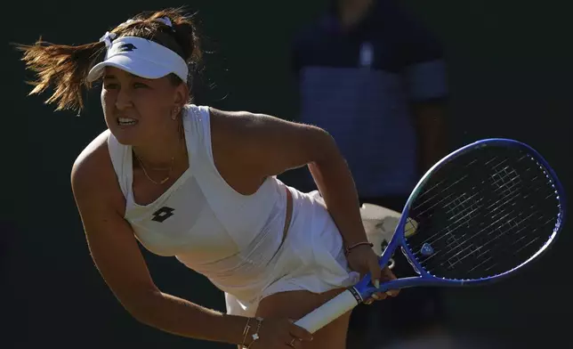 Russia's Kamilla Rakhimova serves to Jasmine Paolini of Italy during their second round women's singles match at the Wimbledon Tennis Championships in London, Wednesday, July 2, 2025. (AP Photo/Joanna Chan)