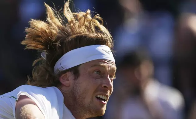 Andrey Rublev of Russia serves to Lloyd Harris of South Africa during their second round men's singles match at the Wimbledon Tennis Championships in London, Wednesday, July 2, 2025. (AP Photo/Joanna Chan)