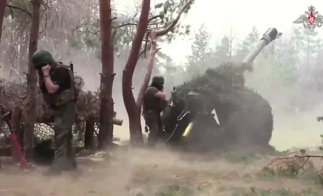 In this photo taken from a video released by the Russian Defense Ministry on Wednesday, July 9, 2025, Russian soldiers fire from D-30 howitzer towards Ukrainian positions in an undisclosed location in Ukraine. (Russian Defense Ministry Press Service via AP)