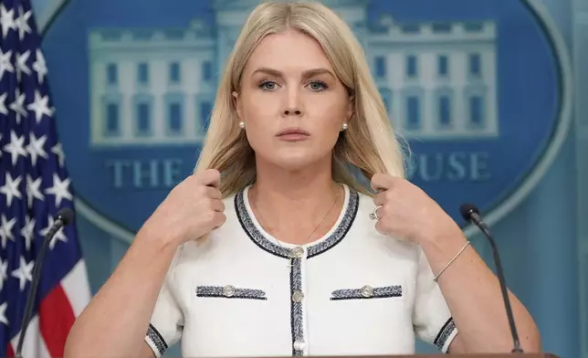 White House press secretary Karoline Leavitt adjusts her hair as she speaks with reporters in the James Brady Press Briefing Room at the White House, Thursday, July 17, 2025, in Washington. (AP Photo/Alex Brandon)