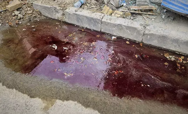 Blood at the site of an Israeli strike stains the roadside two days later in Tehran, Iran, Friday, June 27, 2025. (AP Photo)