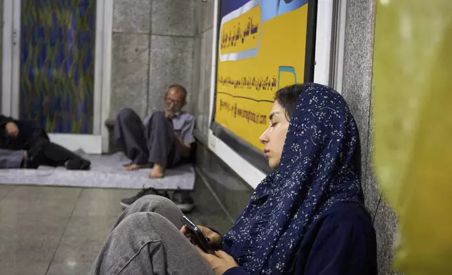 A young woman takes shelter in a metro station following a midnight evacuation alert for Israeli strikes in Tehran, Iran, Tuesday, June 24, 2025. One of the announced missile targets was just 400 meters away, dangerously close to both the station and her home. (AP Photo)