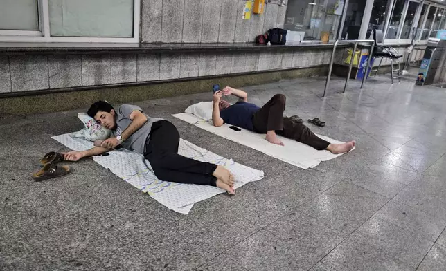 After an emergency evacuation alert, residents seek shelter in a metro station in Tehran, Iran, on Tuesday, June 24, 2025. That night, evacuation alerts were issued for two central neighborhoods in the middle of the night. (AP Photo)