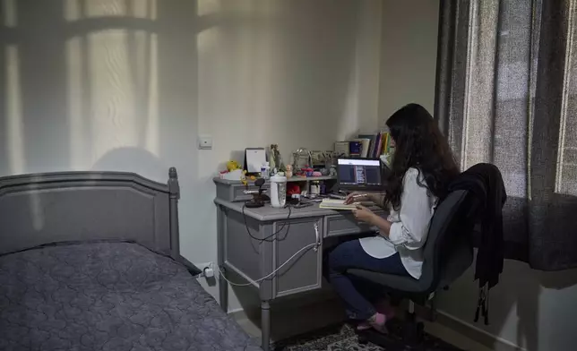 Mastaneh submits an exam online from her home in Tehran, Iran, where she lives with her mother, Maryam, Wednesday, June 25, 2025. She hadn't returned to campus since the start of the 12-day war between Iran and Israel.(AP Photo)