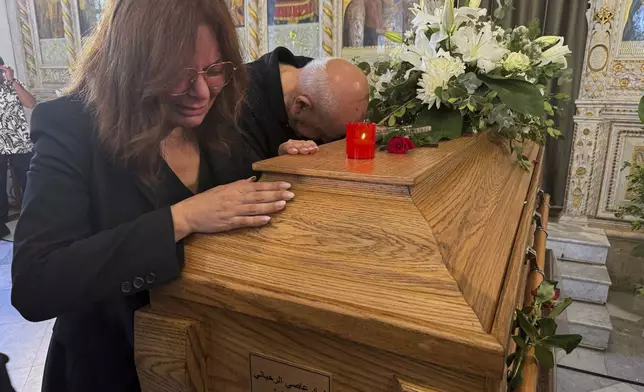 Mourners mourn over the coffin of Ziad Rahbani, a visionary Lebanese composer, playwright, pianist and political provocateur, who died last Saturday at age 69, during Rahbani's funeral at a church in Bekfaya town, mount Lebanon, Monday, July 28, 2025. (AP Photo/Mohammed Anouti)