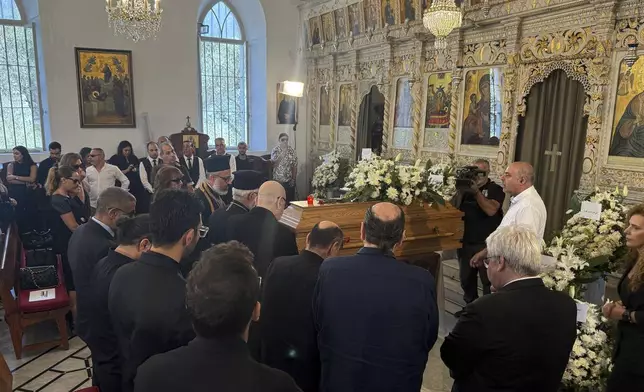 Relatives of Ziad Rahbani, a visionary Lebanese composer, playwright, pianist and political provocateur, who died last Saturday at age 69, gather around his coffin during his funeral at a church in Bekfaya town, mount Lebanon, Monday, July 28, 2025. (AP Photo/Mohammed Anouti)