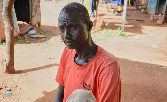 Shoemaker Emmanuel Achuil works under the shade of a tarpaulin in Wau, South Sudan, June 13, 2025. (AP Photo/Michael Atit)