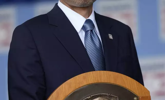 Baseball Hall of Fame inductee Ichiro Suzuki poses for a photo with his plaque after the National Baseball Hall of Fame induction ceremony in Cooperstown, N.Y., Sunday, July 27, 2025. (AP Photo/Seth Wenig)