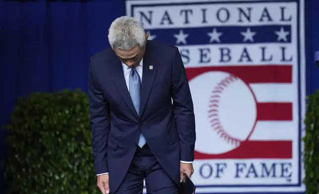 Baseball Hall of Fame inductee Ichiro Suzuki bows as he arrives on stage during the National Baseball Hall of Fame induction ceremony in Cooperstown, N.Y., Sunday, July 27, 2025. (AP Photo/Seth Wenig)