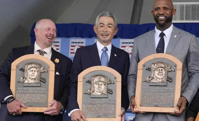 Baseball Hall of Fame inductees Billy Wagner, left, Ichiro Suzuki, center, and CC Sabathia, right, pose for a photo at the National Baseball Hall of Fame induction ceremony in Cooperstown, N.Y., Sunday, July 27, 2025. (AP Photo/Seth Wenig)