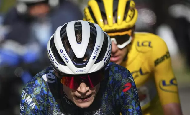 FILE - Denmark's Jonas Vingegaard is followed by Slovenia's Tadej Pogacar, wearing the overall leader's yellow jersey, during the twentieth stage of the Tour de France cycling race over 132.8 kilometers (82.5 miles) with start in Nice and finish in La Couillole pass, France, Saturday, July 20, 2024. (AP Photo/Daniel Cole, File)