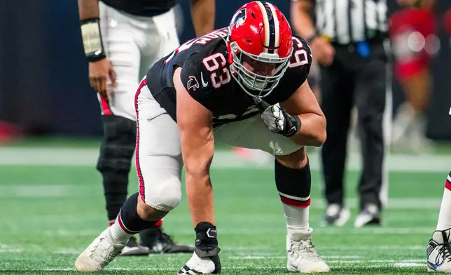 FILE - Atlanta Falcons guard Chris Lindstrom (63) lines up during the first half of an NFL football game against the New York Giants, Sunday, Dec. 22, 2024, in Atlanta. The Falcons defeated the Giants 34-7. (AP Photo/Danny Karnik, File)