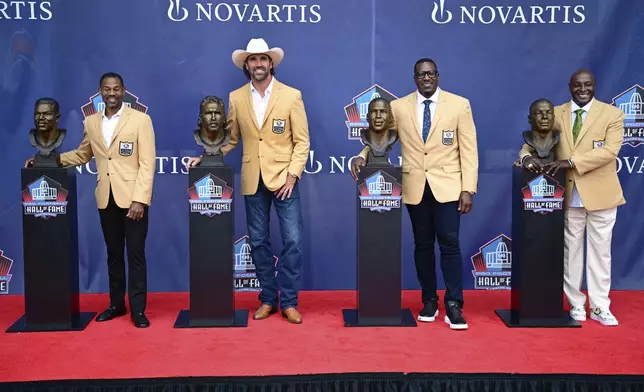 The Pro Football Hall of Fame Class of 2025 from left are Eric Allen, Jared Allen, Antonio Gates, and Sterling Sharpe pose with they busts following their induction into the Pro Football Hall of Fame, Saturday, Aug. 2, 2025, in Canton, Ohio. (AP Photo/David Dermer)