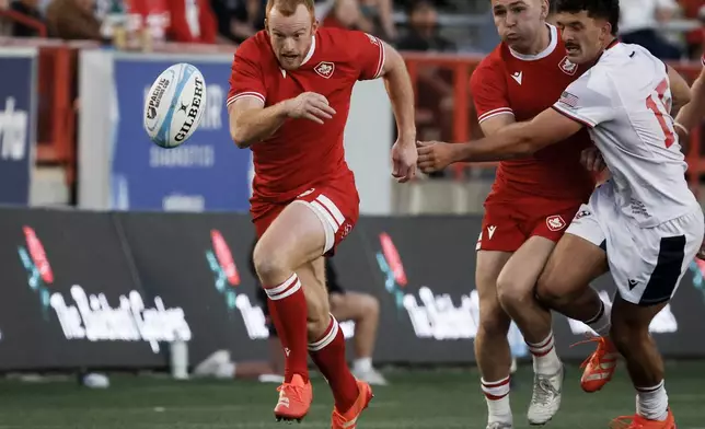 United States' Erich Storti, right, tries to get to Canada's Noah Flesch, left, before Flesch scores a try during second-half Pacific Nations Cup rugby match action in Calgary, Alberta, Friday, Aug. 22, 2025. (Jeff McIntosh/The Canadian Press via AP)