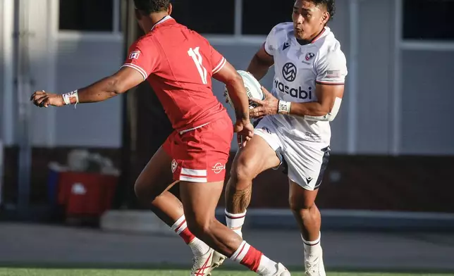 United States' Lauina Futi, right, looks to get past Canada's Josiah Morra, left, during first-half Pacific Nations Cup rugby match action in Calgary, Alberta, Friday, Aug. 22, 2025. (Jeff McIntosh/The Canadian Press via AP)