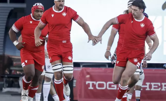 Canada's Tyler Ardron, center, celebrates after his try with teammates during first-half Pacific Nations Cup rugby match action against the United States in Calgary, Alberta, Friday, Aug. 22, 2025. (Jeff McIntosh/The Canadian Press via AP)
