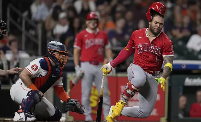 Los Angeles Angels' Yoan Moncada (5) reacts after getting his by his foul ball during the ninth inning of a baseball game against the Houston Astros in Houston, Saturday, Aug. 30, 2025. (AP Photo/Ashley Landis)