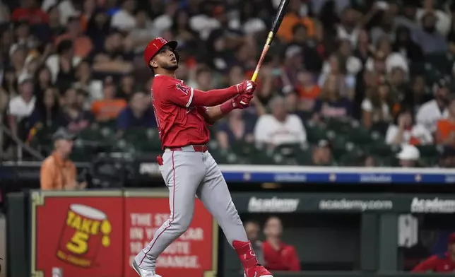Los Angeles Angels' Oswald Peraza singles, allowing Luis Rengifo and Logan O'Hoppe to score during the ninth inning of a baseball game against the Houston Astros in Houston, Saturday, Aug. 30, 2025. (AP Photo/Ashley Landis)