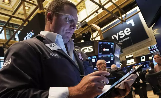 Trader Ryan Falvey works on the floor of the New York Stock Exchange, Thursday, Aug. 14, 2025. (AP Photo/Richard Drew)