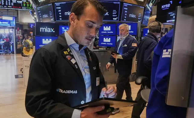 Trader Dylan Halvorsan works on the floor of the New York Stock Exchange, Thursday, Aug. 14, 2025. (AP Photo/Richard Drew)