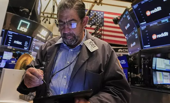 Trader Robert Oswald works on the floor of the New York Stock Exchange, Thursday, Aug. 14, 2025. (AP Photo/Richard Drew)