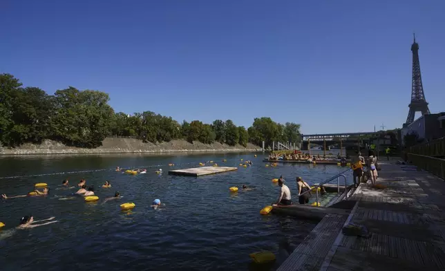 People swim in the Seine river, Monday, Aug. 11, 2025 in Paris. (AP Photo/Aurelien Morissard)