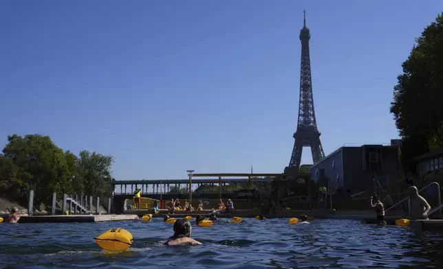 People swim in the Seine river, Monday, Aug. 11, 2025 in Paris. (AP Photo/Aurelien Morissard)