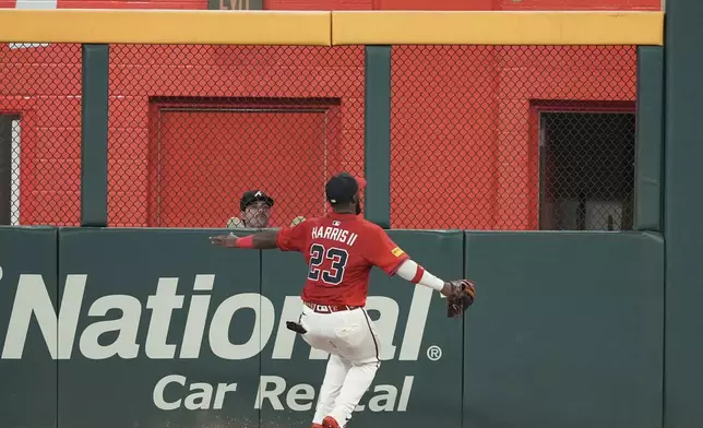 Atlanta Braves outfielder Michael Harris II (23) misses a fly ball hit by New York Mets Mark Vientos (27) in the fourth inning of a baseball game, Friday, Aug. 22, 2025, in Atlanta. (AP Photo/Brynn Anderson)