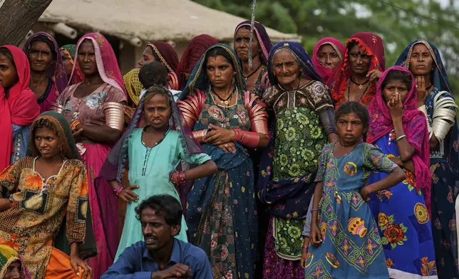 Women prepare to leave after the performance of a Pakistani folk musician Sham Bhai at a village in Umerkot, a district of Pakistan's southeastern Sindh province, Thursday, July 17, 2025. (AP Photo/Fareed Khan)