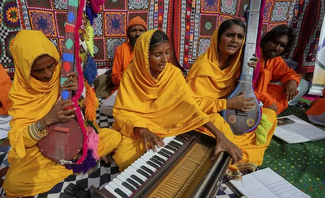 Pakistani folk musician Sham Bhai, second from right, performs with her team members at a village in Umerkot, a district of Pakistan's southeastern Sindh province, Thursday, July 17, 2025. (AP Photo/Fareed Khan)