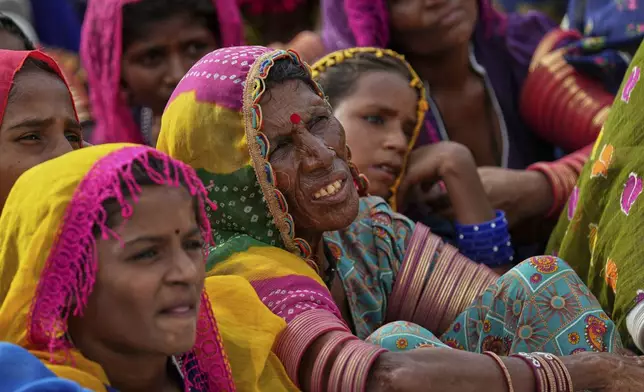 Villagers watch a performance of a Pakistani folk musician Sham Bhai at a village in Umerkot, a district of Pakistan's southeastern Sindh province, Thursday, July 17, 2025. (AP Photo/Fareed Khan)