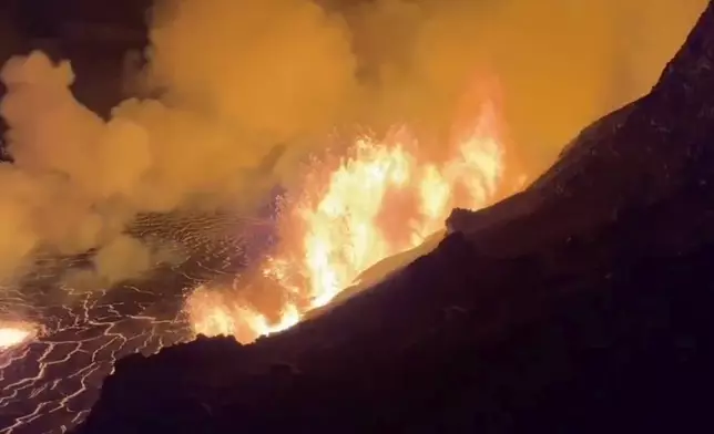 FILE - This image from video provided by the U.S. Geological Survey shows a lava lake erupting on the west caldera wall of the Kīlauea volcano in Hawaii, on Dec. 23, 2024. (USGS via AP, File)